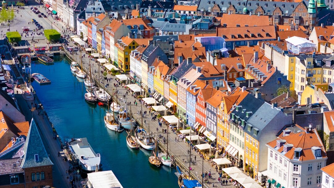 Wide view of Copenhagen harbourfront promenade in soft morning light